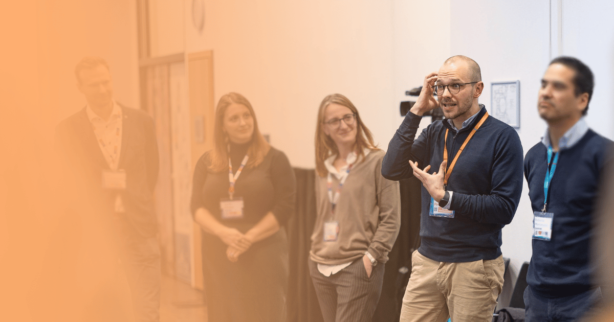 Diverse team of professionals collaborating and building on each other's ideas during an interactive improv-based innovation training.